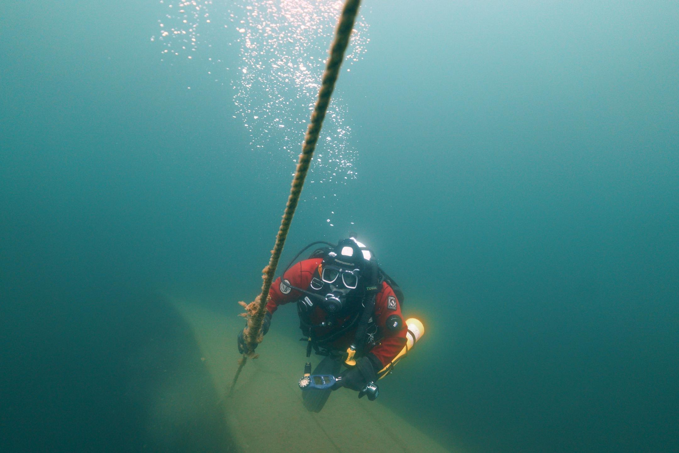 Jim Christenson a diver with the Great Lakes Shipwreck Preservation Society from Columbia Heights, looked up the decent line leading from a mooring buoy to the stern winch on the Madeira, a schooner barge that sank in Lake Superior on November 28, 1905, during a project dive.