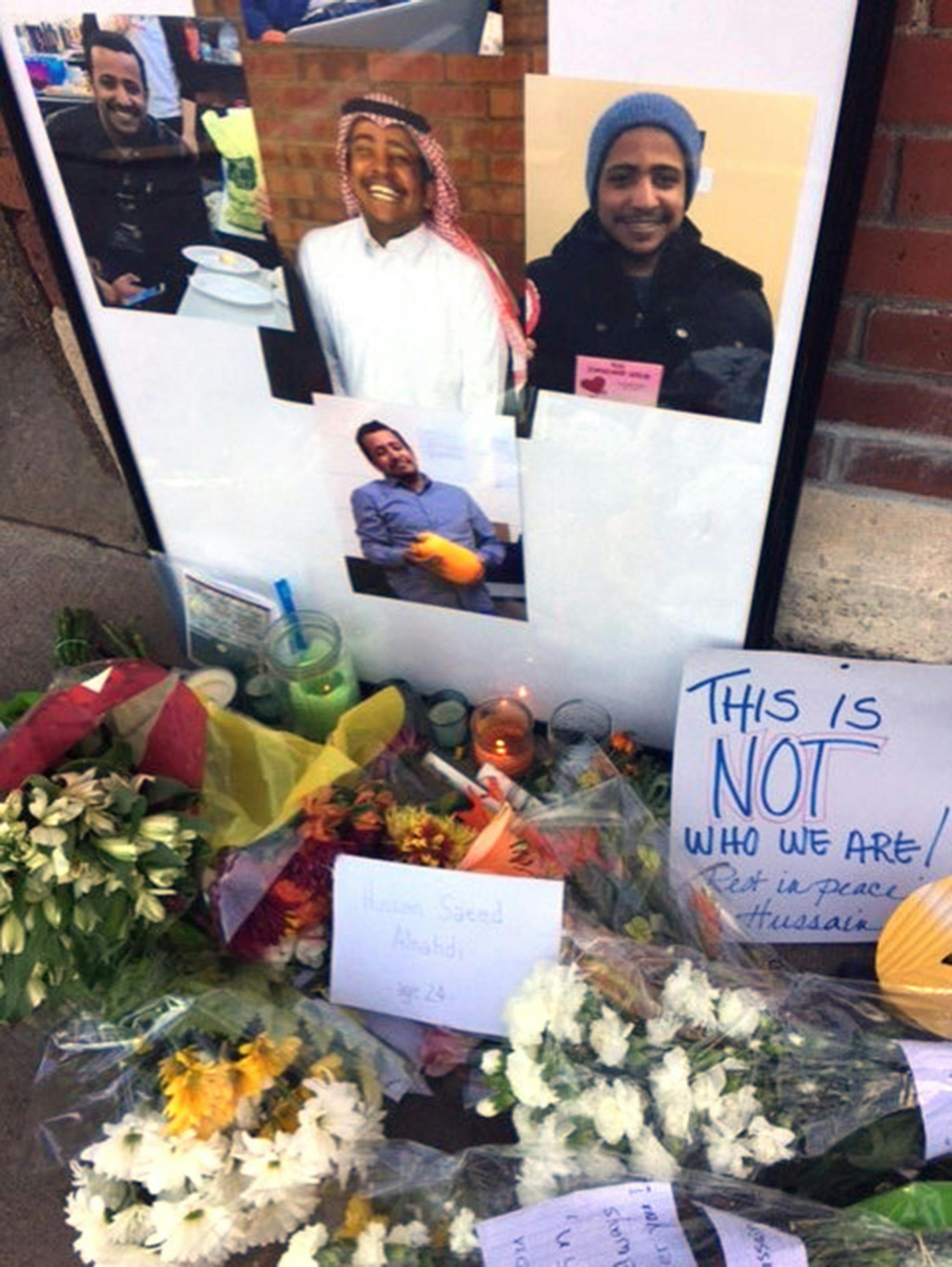 Photos are placed at the memorial for Hussain Saeed Alnahdi, 24, who died Monday, one day after being assaulted on a street in downtown Menomonie. (Karen Herzog/Milwaukee Journal Sentinel/TNS) ORG XMIT: 1192546