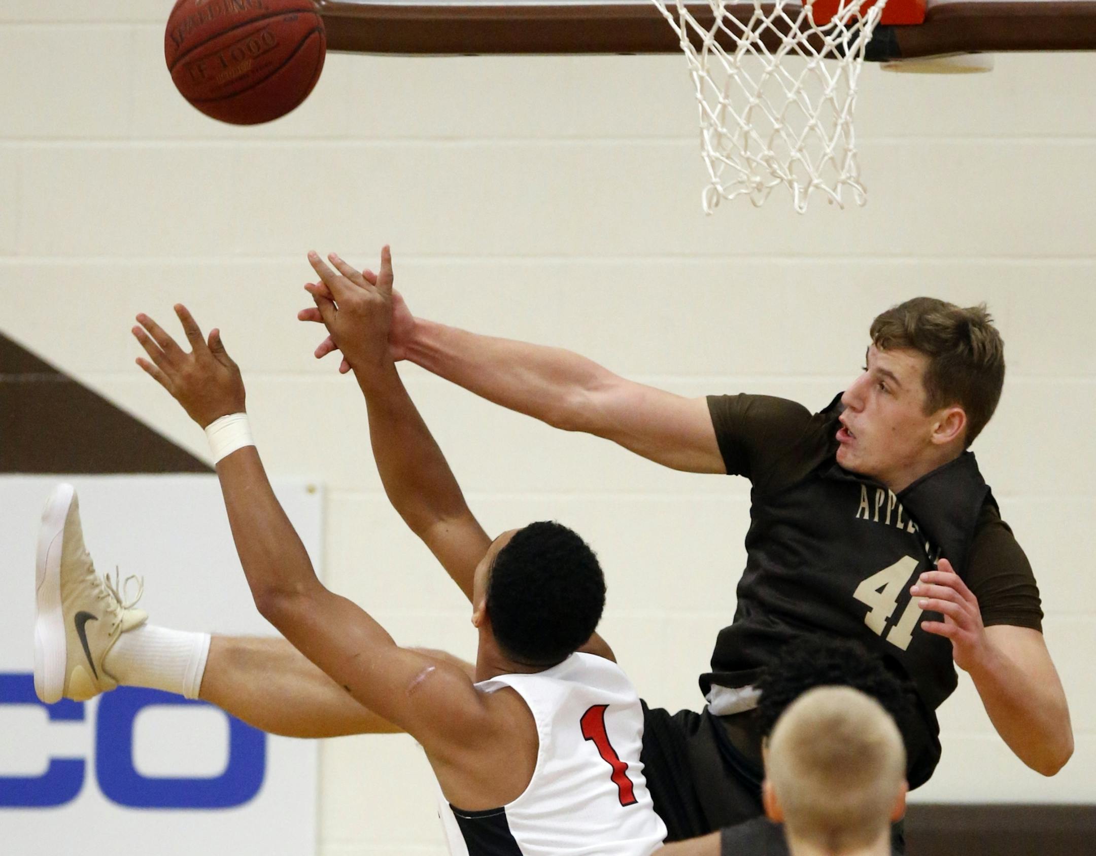 Jalen Suggs(1) clashes with Spencer Rolland(41) of Apple Valley for the ball.