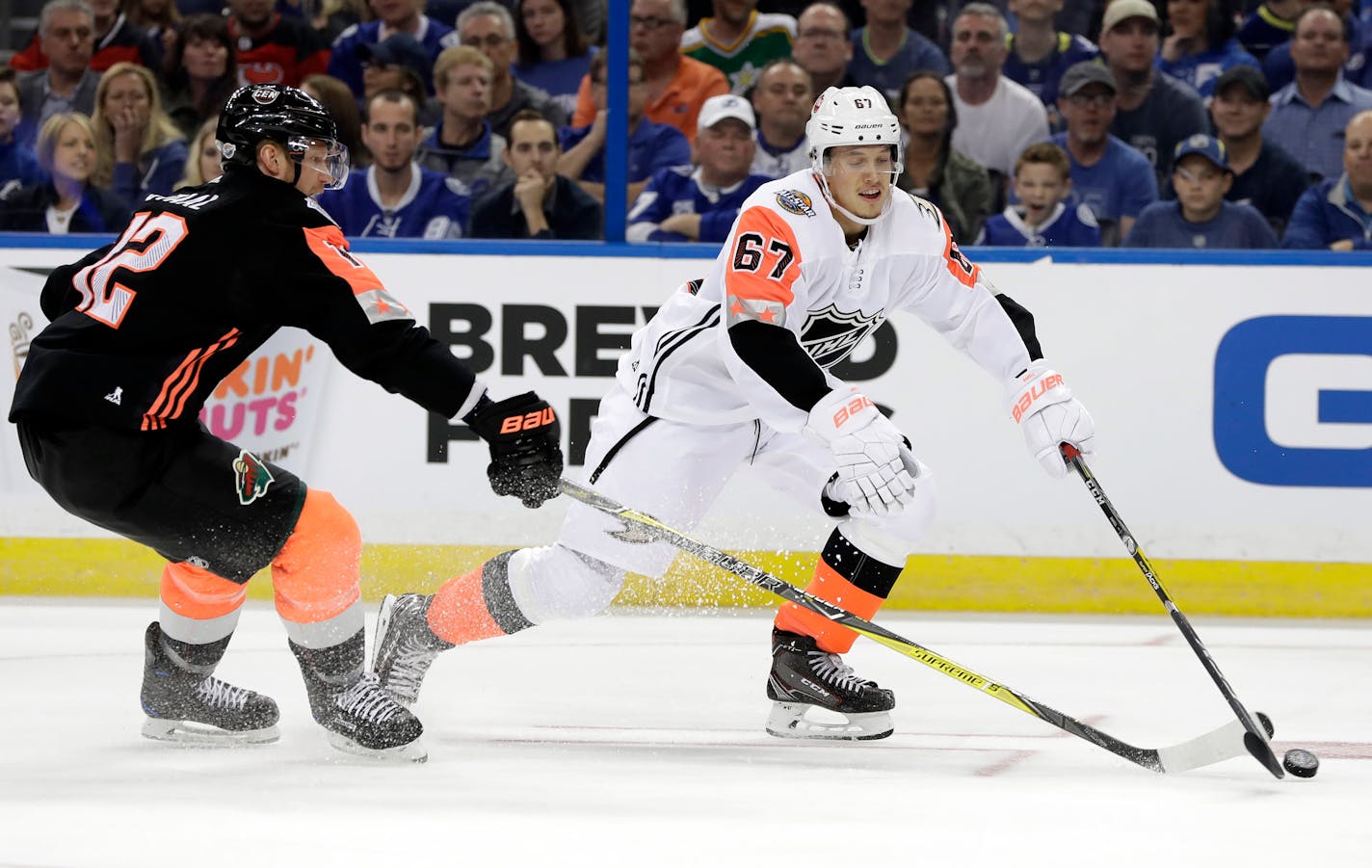 Pacific Division's Rickard Rakel, right, of the Anaheim Ducks, handled the puck as Central Division's Eric Staal of the Wild, defended during the NHL All-Star Game on Sunday in Tampa, Fla.