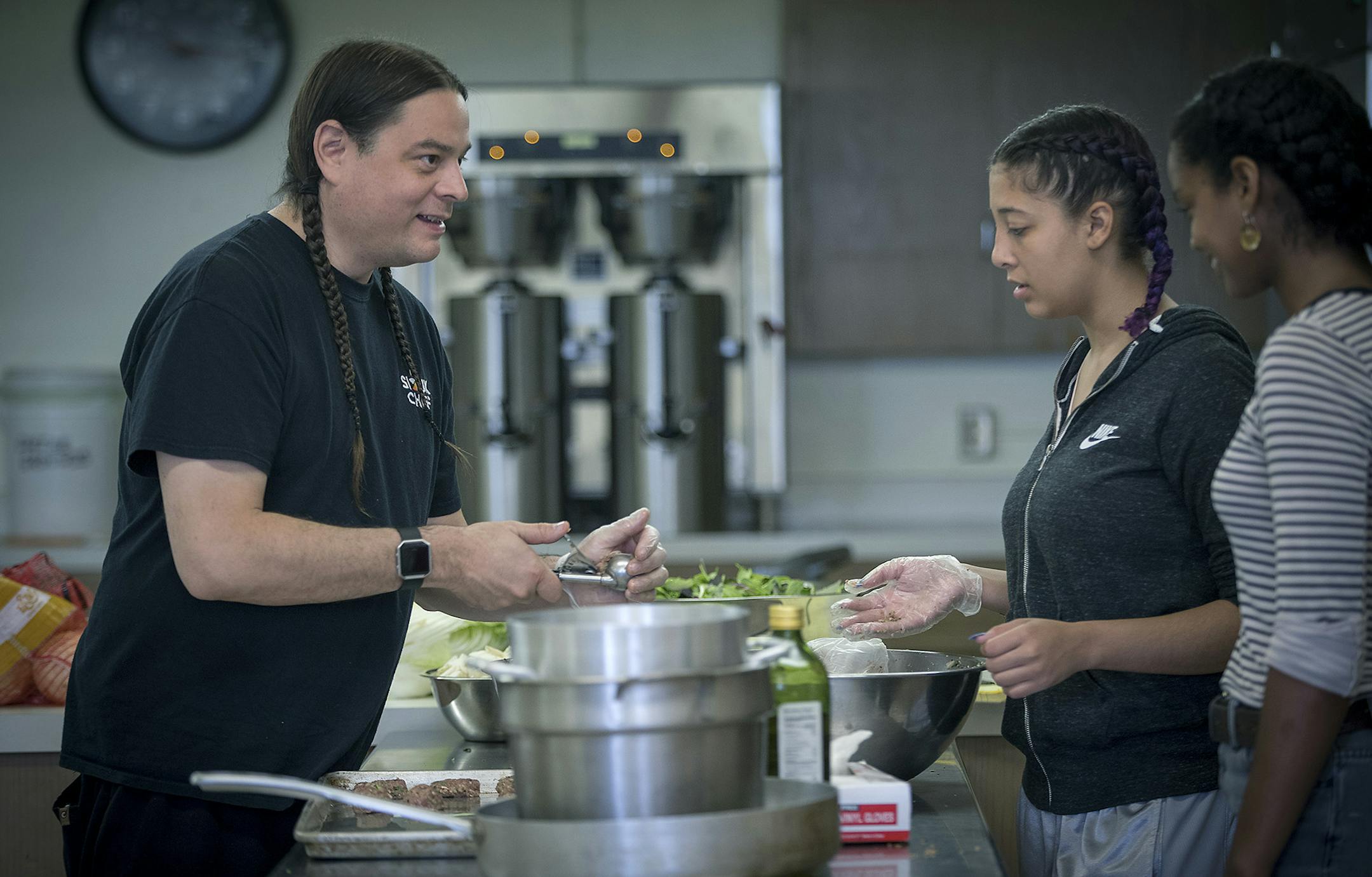 Sean Sherman, the 2018 James Beard award-winning Sioux Chef, showed Tajah Tempest, center, and Saba Andualem how to roll up meatballs at Urban Roots, Tuesday, June 26, 2018 in St. Paul, MN. Sherman was a guest teacher for the St. Paul youth nonprofit Urban Roots. Every summer the organization invites local chefs to cook with the teenagers who participate in the program. ] ELIZABETH FLORES &#xef; liz.flores@startribune.com