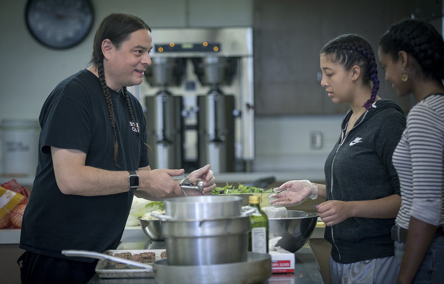 Sean Sherman, the 2018 James Beard award-winning Sioux Chef, showed Tajah Tempest, center, and Saba Andualem how to roll up meatballs at Urban Roots, Tuesday, June 26, 2018 in St. Paul, MN. Sherman was a guest teacher for the St. Paul youth nonprofit Urban Roots. Every summer the organization invites local chefs to cook with the teenagers who participate in the program. ] ELIZABETH FLORES &#xef; liz.flores@startribune.com