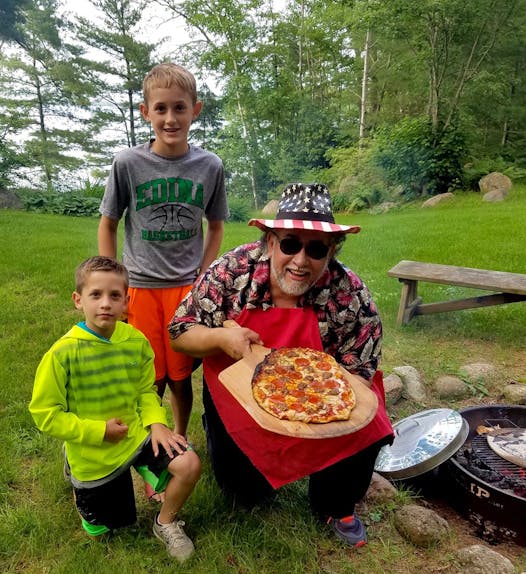 “Famous Dave” Anderson has a cabin in Wisconsin where he grows vegetables and grills as much as he wants. Dave and his grandsons, Miles and Cooper, cooked up some grilled pizza.