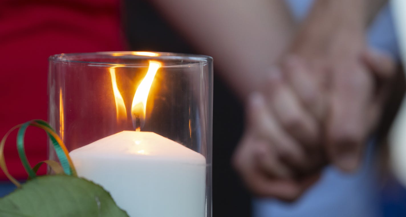 A candle representing one of the victims of a deadly shooting with multiple fatalities at Santa Fe High School burns in a memorial at a vigil Friday, May 18, 2018, in Santa Fe, Texas. (Stuart Villanueva/The Galveston County Daily News via AP)