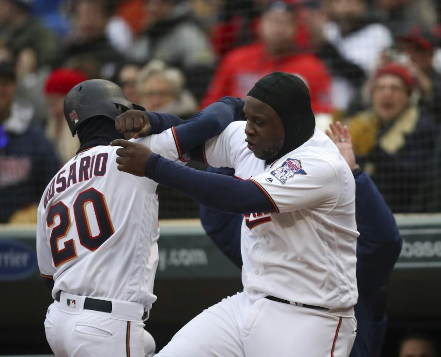 Minnesota Twins third baseman Miguel Sano (22) greeted Minnesota Twins left fielder Eddie Rosario (20) to celebrate his 8th inning home run that put the Twins ahead of Mariners 4-2.