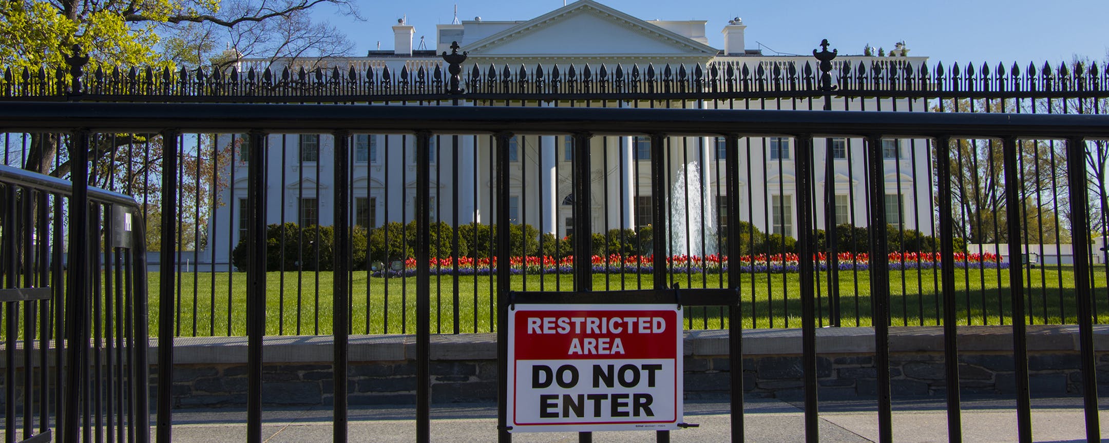 The White House is viewed from Pennsylvania Avenue behind two layers of security fencing on a Spring Day in Washington, on Tuesday, April 5, 2016.(AP Photo/Jon Elswick) ORG XMIT: APSTK