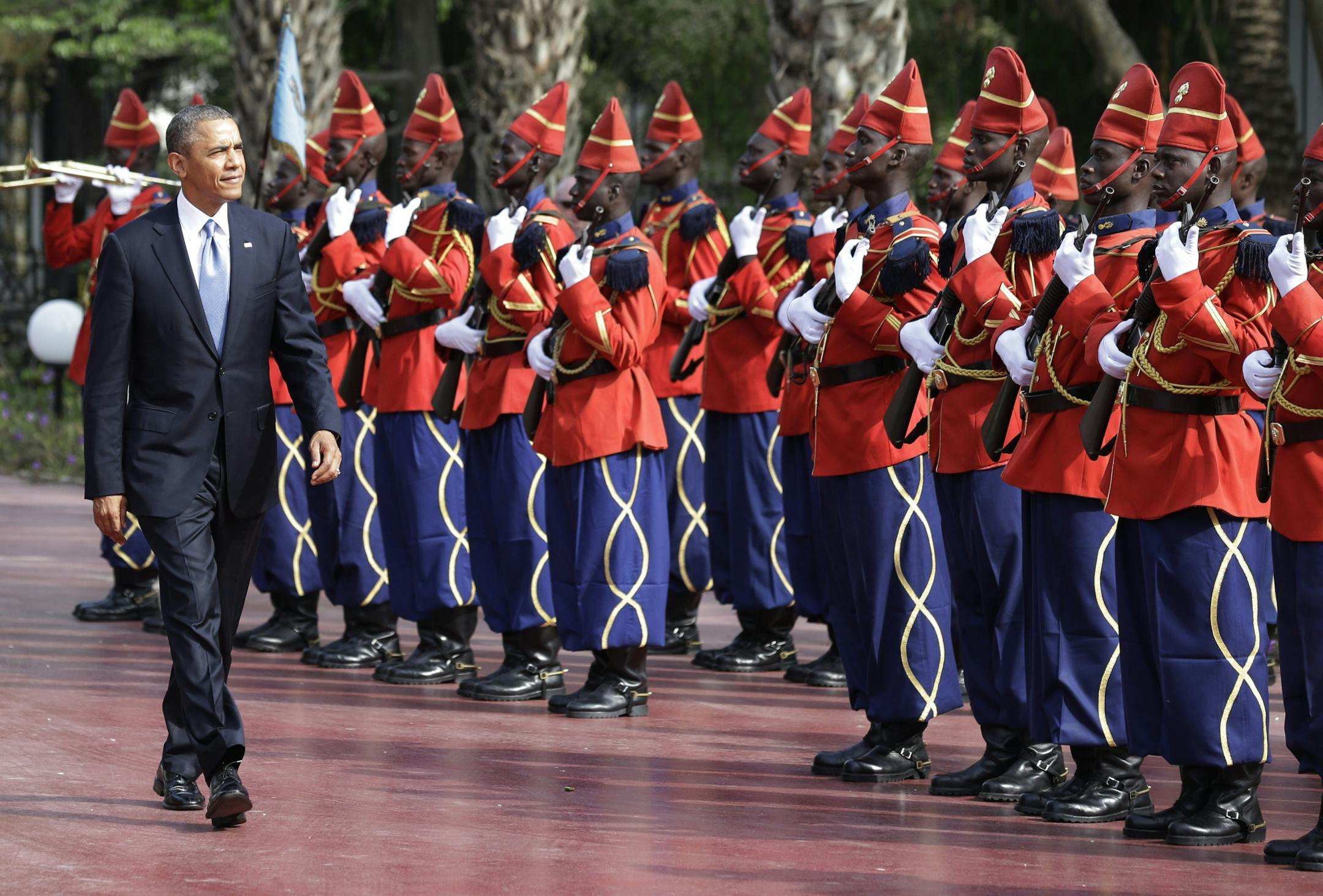 U.S. President Barack Obama is welcomed by a Senegalese honor guard as he arrives at the presidential palace in Dakar, Senegal, Thursday, June 27, 2013. President Obama landed in Senegal Wednesday night to kick off a weeklong trip to Africa, a three-country visit aimed at overcoming disappointment on the continent over the first black U.S. president's lack of personal engagement during his first term.