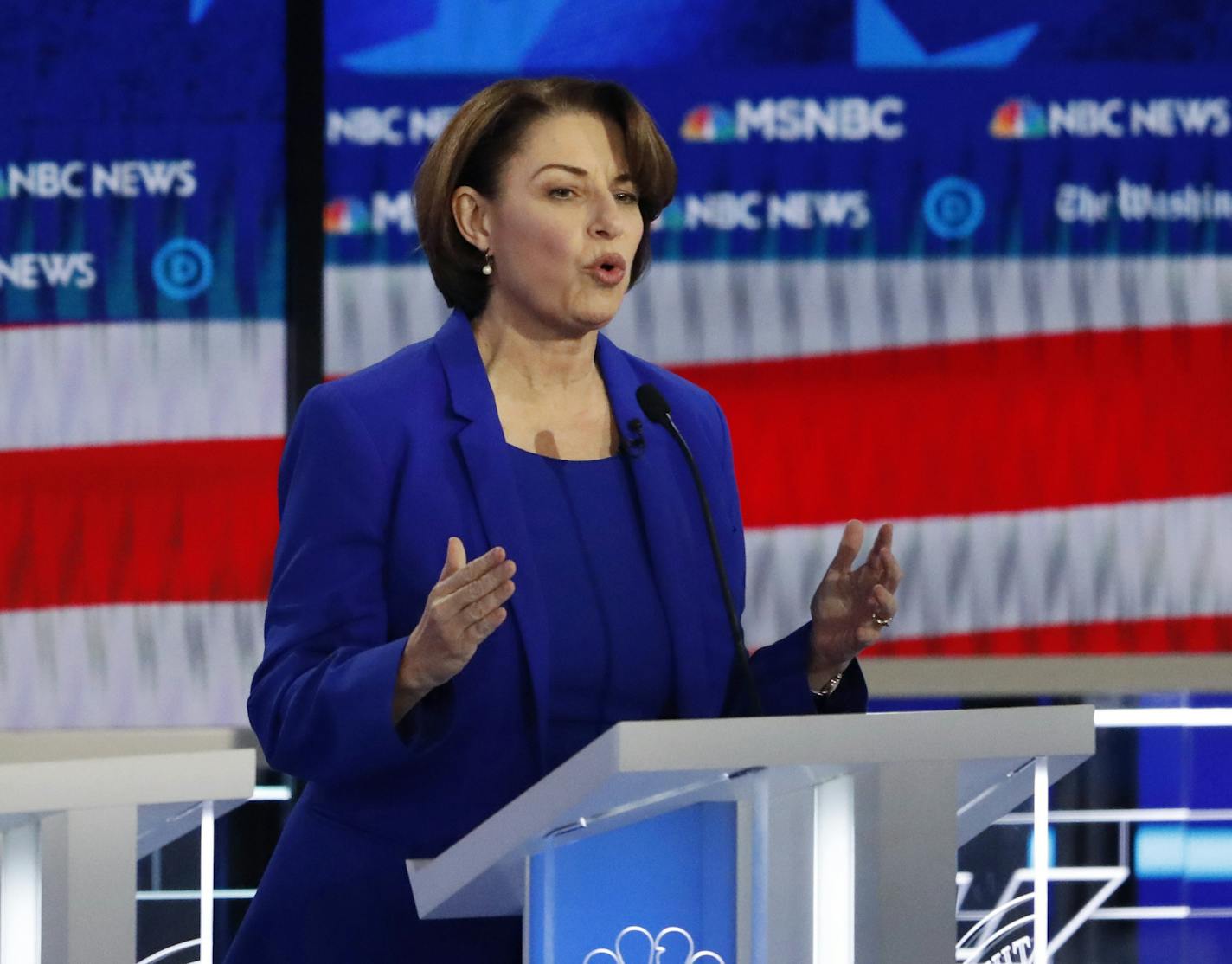 Democratic presidential candidate Sen. Amy Klobuchar, D-Minn., center, speaks as South Bend, Ind., Mayor Pete Buttigieg and Rep. Tulsi Gabbard, D-Hawaii, listen during a Democratic presidential primary debate, Wednesday, Nov. 20, 2019, in Atlanta. (AP Photo/John Bazemore)