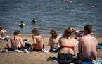 People sunbathed June 17 on the beach at Lake Nokomis in Minneapolis.