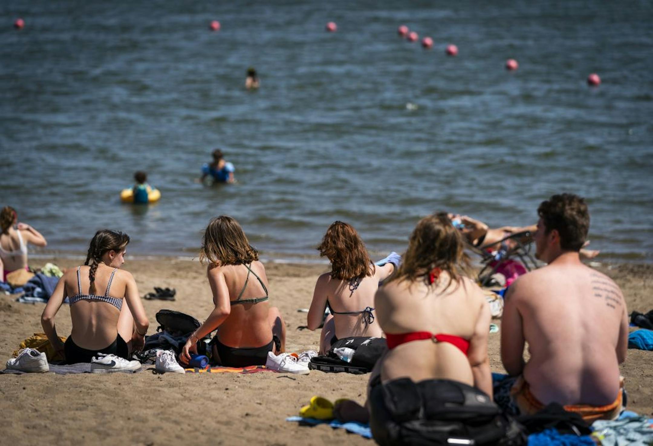 People sunbathed June 17 on the beach at Lake Nokomis in Minneapolis.