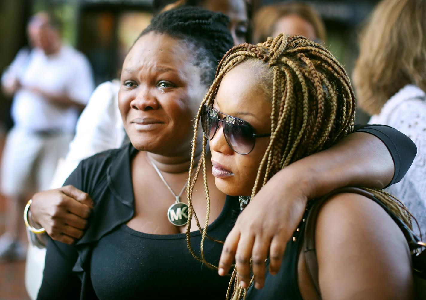 Barway Collins' mother, Louise Karluah, left, and his stepmother, Yamah Collins, hugged each other after attending the Monday court hearing.