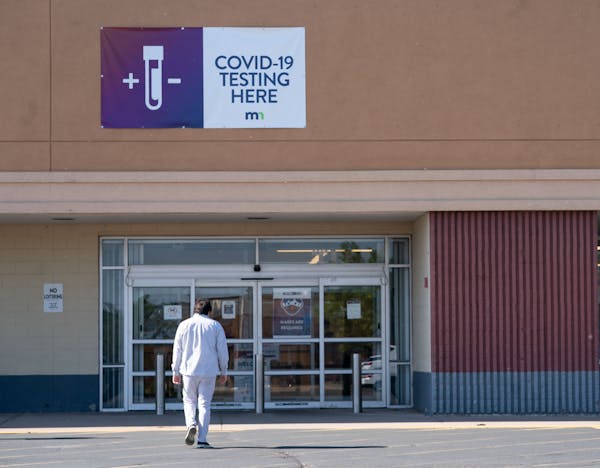 A person walks into the COVID-19 test-to-treat site June 9 at the Starlite Center in Brooklyn Park, Minn. 