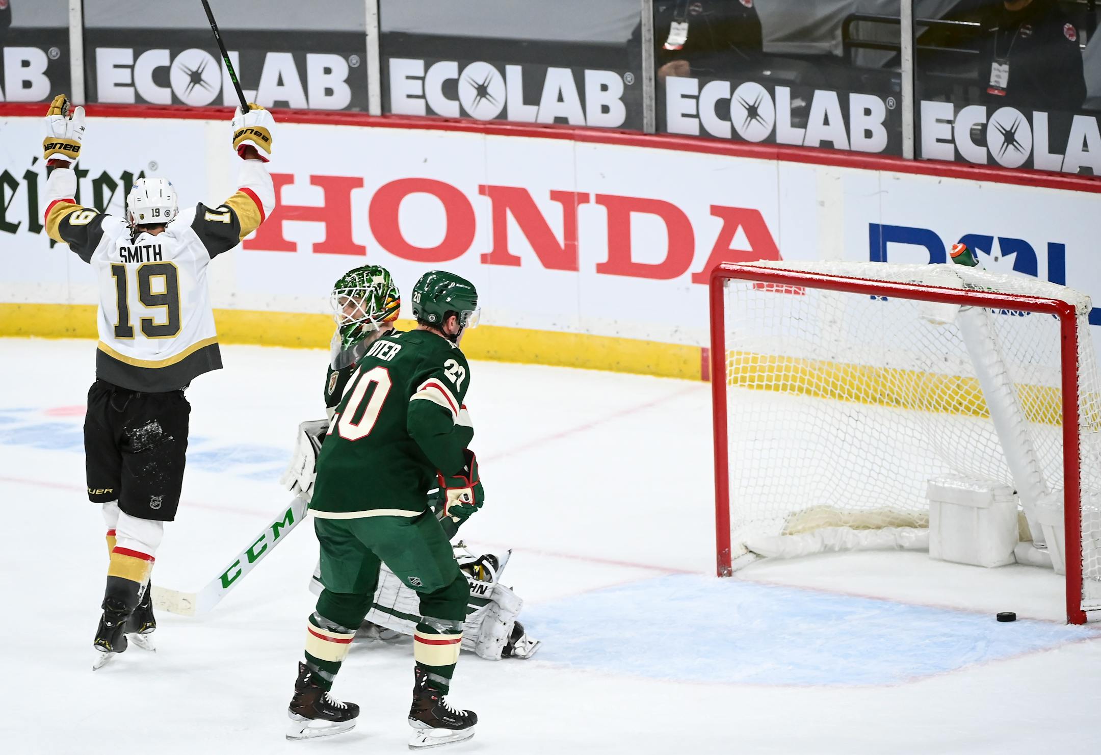 Minnesota Wild goaltender Kaapo Kahkonen (34) and defenseman Ryan Suter (20) looked on as Vegas Golden Knights right wing Reilly Smith (19) and his team celebrated a third period goal by defenseman Dylan Coghlan (52).