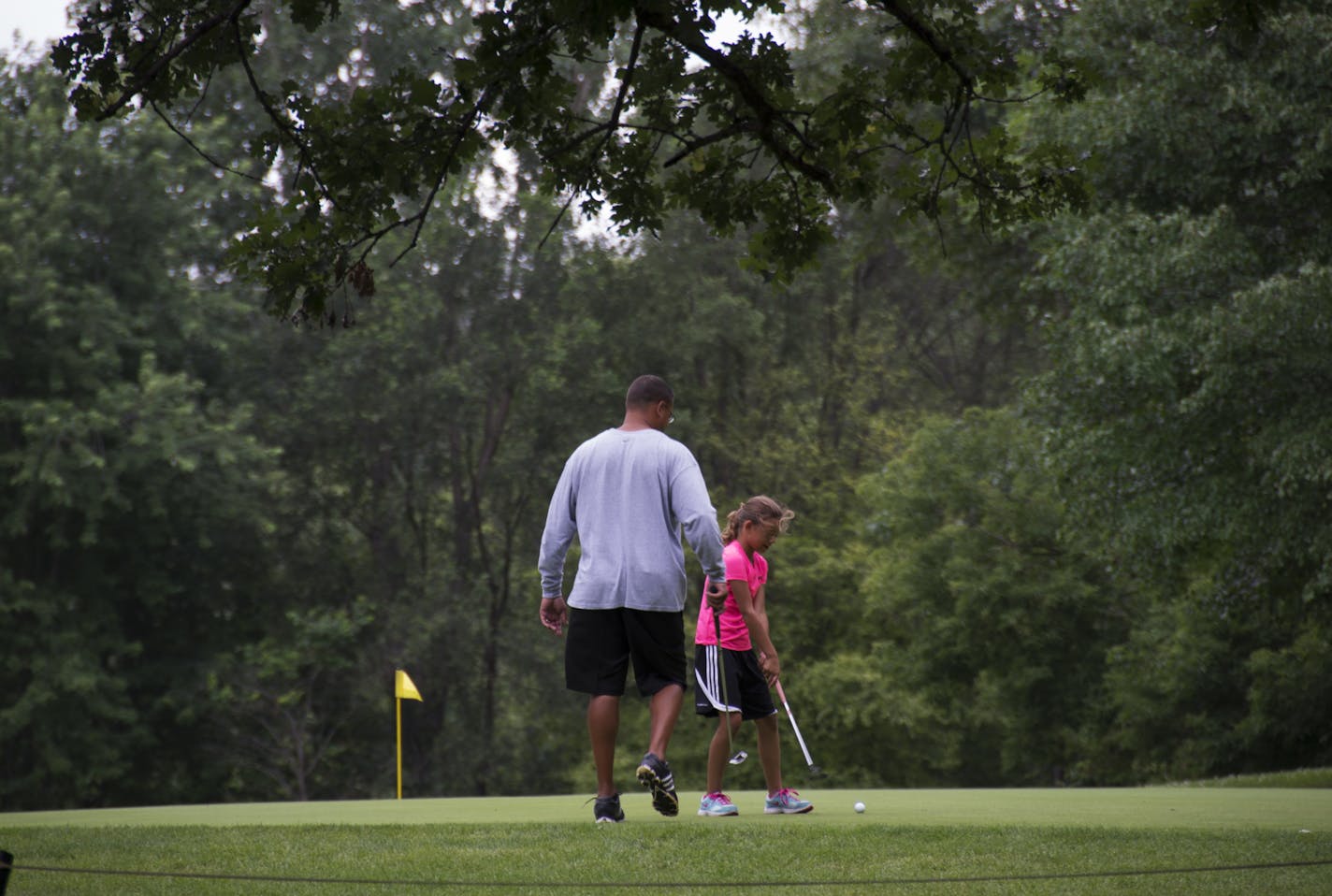 Jesse Dolinar and daughter Jordan Dolinar practice on the putting green at the Theodore Wirth Golf Course. ] Golf in Minnesota -- The Twin Cities invested heavily in the Golf Boom that started the millennium, and now we're seeing the fallout. DAVIDBREWSTER/STAR TRIBUNE