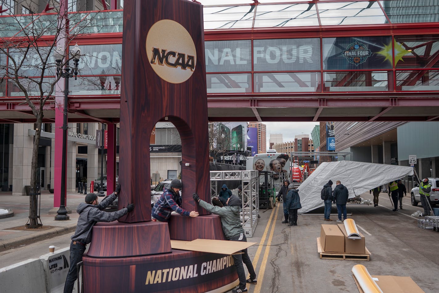 Crews install a replica of the Women's NCAA Championship trophy on 1st avenue in front of Target Center in Minneapolis, Minn., on Thursday, March 31, 2022.