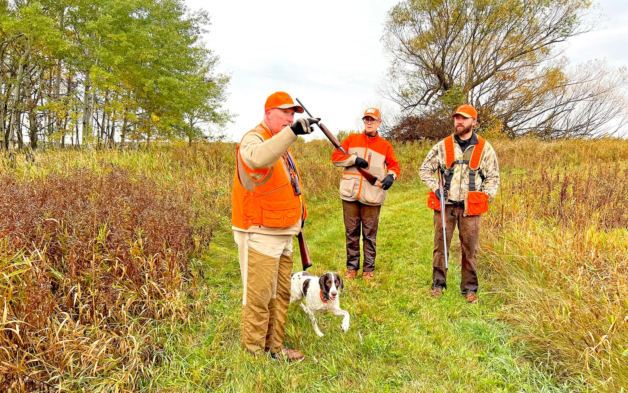 Kenny Reed, left, his wife, Beth Reed, and Kris Oja made a plan Saturday morning while hunting on the pheasant opener north of the Twin Cities in Pine County, where ringneck numbers are increasing.