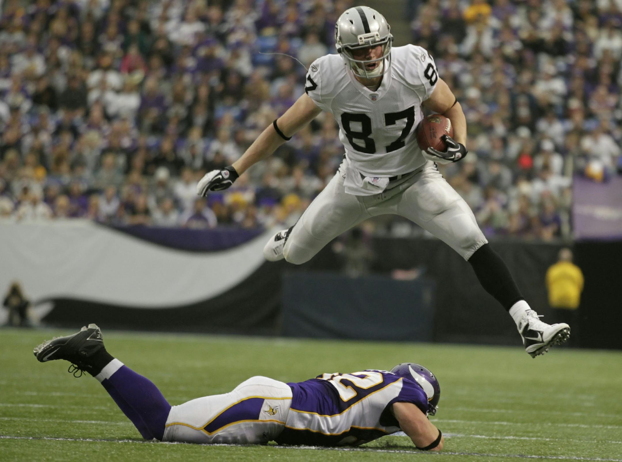 Raiders tight end Kevin Boss jumped over Vikings linebacker Chad Greenway after picking up a first down in the third quarter.