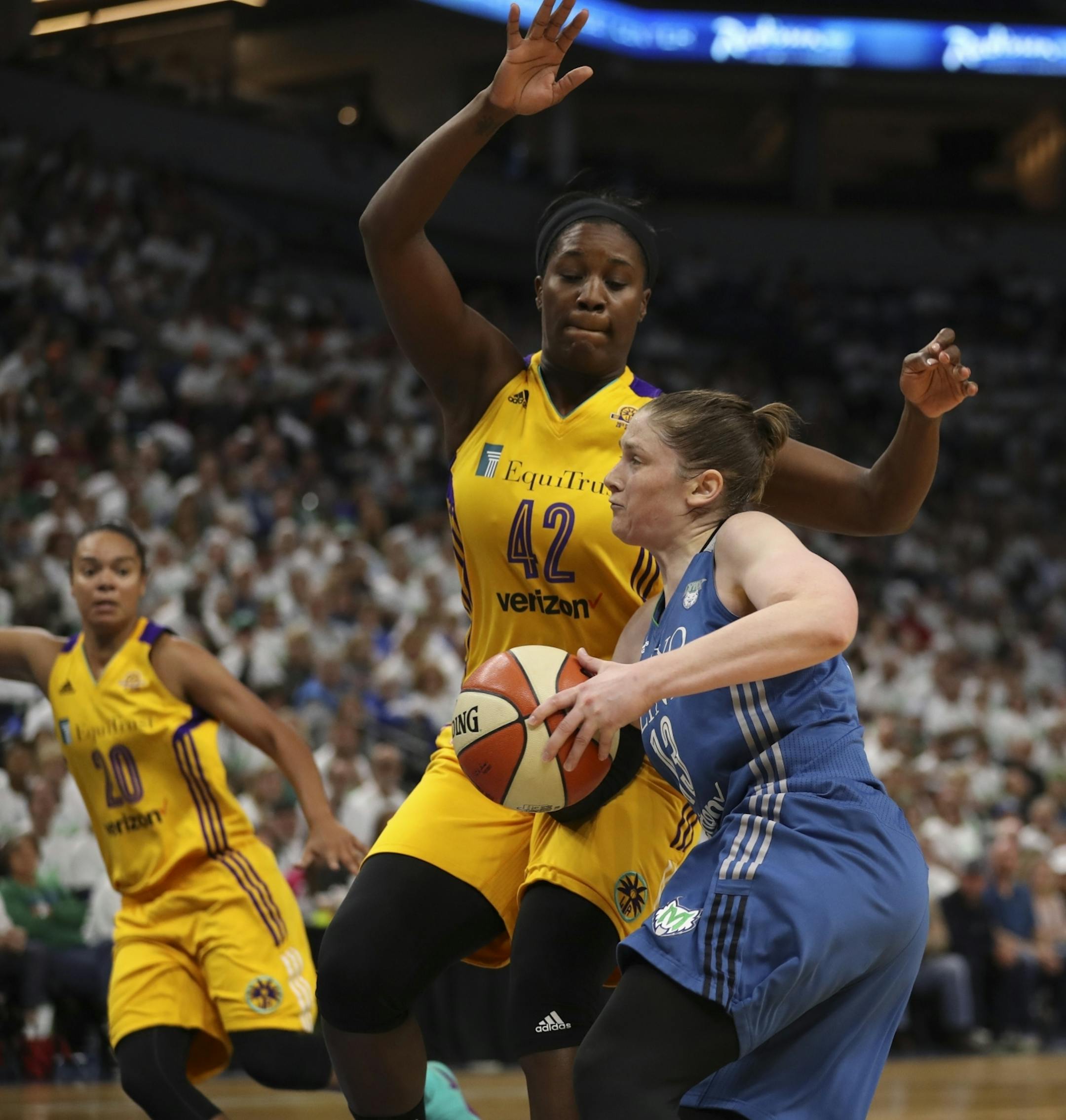 Minnesota Lynx guard Lindsay Whalen (13) drove to the net against Los Angeles Sparks center Jantel Lavender (42) in the third quarter.
