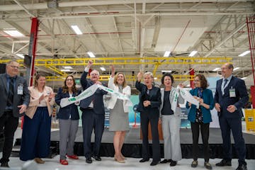 U.S. Department of Energy Secretary Jennifer Granholm, center in black, cuts the ribbon at the opening of Accelera by Cummins' first hydrogen electrol