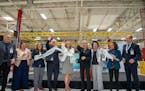 U.S. Department of Energy Secretary Jennifer Granholm, center in black, cuts the ribbon at the opening of Accelera by Cummins' first hydrogen electrol