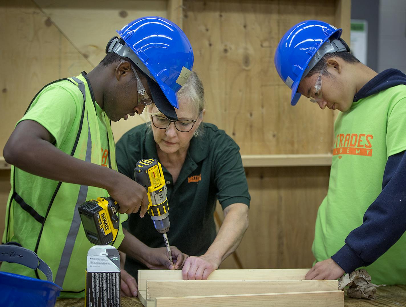 Adan Yah Yah, cq, 17, left, and Eh Htee Kaw, cq, 16, right, learned how to make wooden stools from Janeen Hedren, the Youth Lead for Minnesota Trades Academy during apprentice training at Central High School, Monday, June 2, 2018 in St. Paul, MN. ] ELIZABETH FLORES &#xef; liz.flores@startribune.com