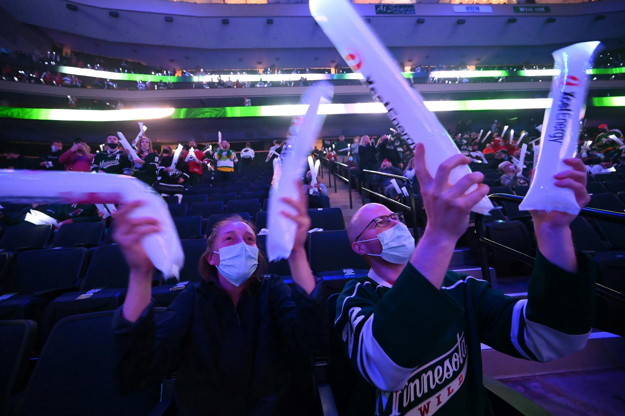 Elise Hanson, left, and her boyfriend, Nick Stokfisz cheer before the Minnesota Wild exited the tunnel onto the ice. Both are from Minneapolis.