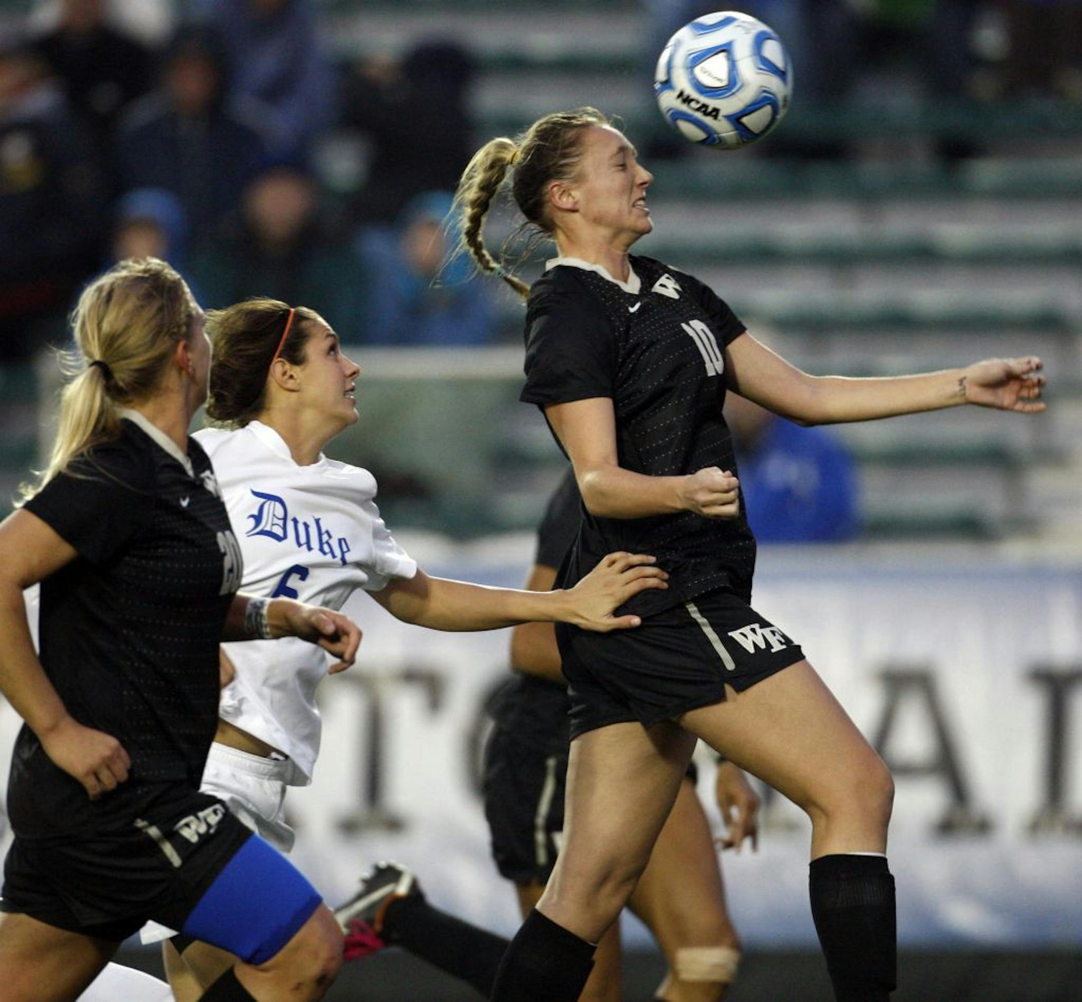 Wake Forest's Kim Marshall (10) heads the ball away from Duke's Callie Simpkins (6) during the first half of the ACC women's soccer championship semifinal at WakeMed Soccer Park in Cary, North Carolina, Friday, November 4, 2011. Wake Forest defeated Duke, 2-1.