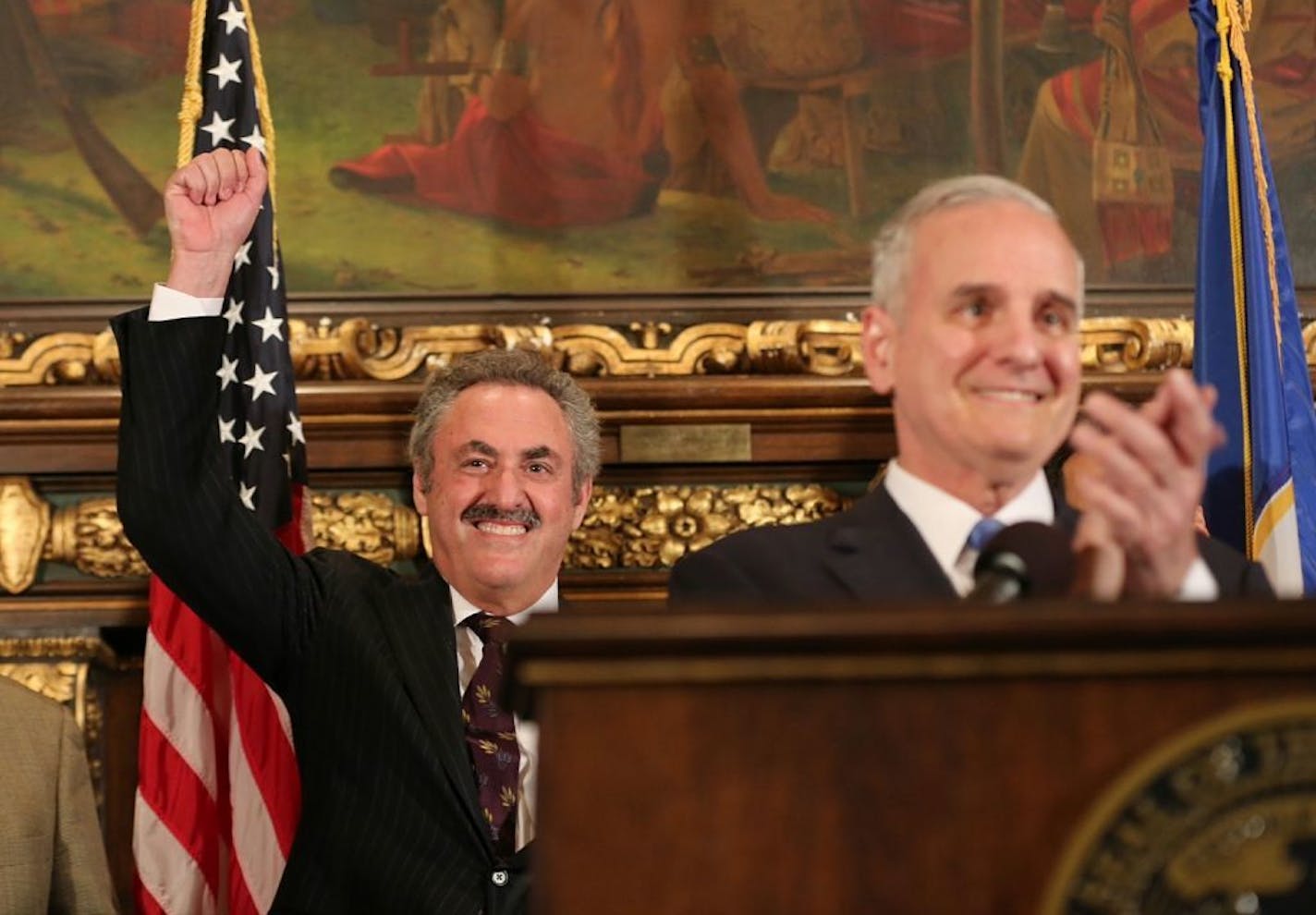 Zygi Wilf raised his fist as fans sang the Vikings song and Gov. mark Dayton spoke a press conference after the Vikings stadium that was passed in the Senate and House on May 10, 2012 at the State Capitol in St. Paul, Minn.