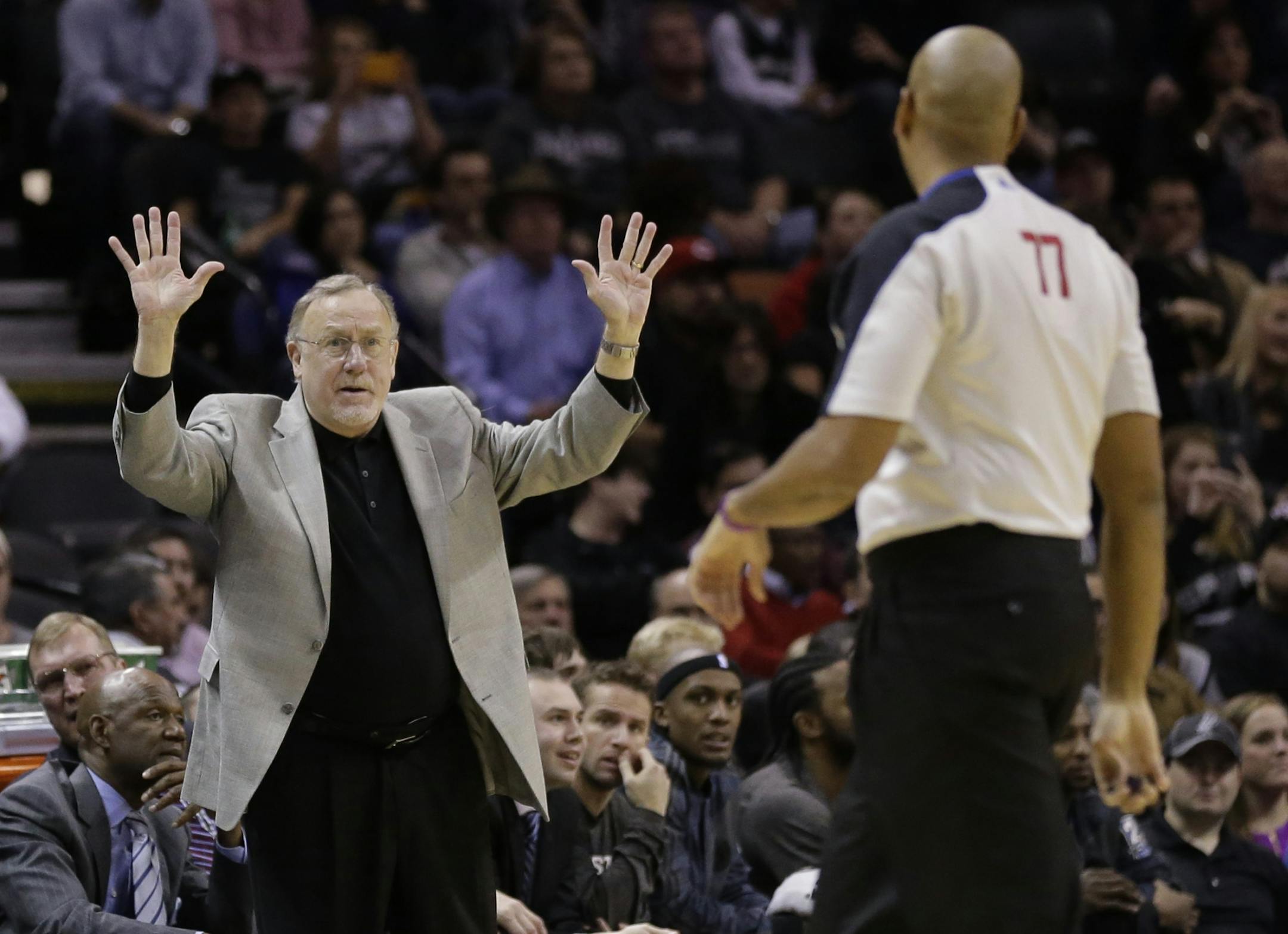 Minnesota Timberwolves coach Rick Adelman, left, argues a call during the second half on an NBA basketball game against the San Antonio Spurs, Sunday, Jan. 12, 2014, in San Antonio.