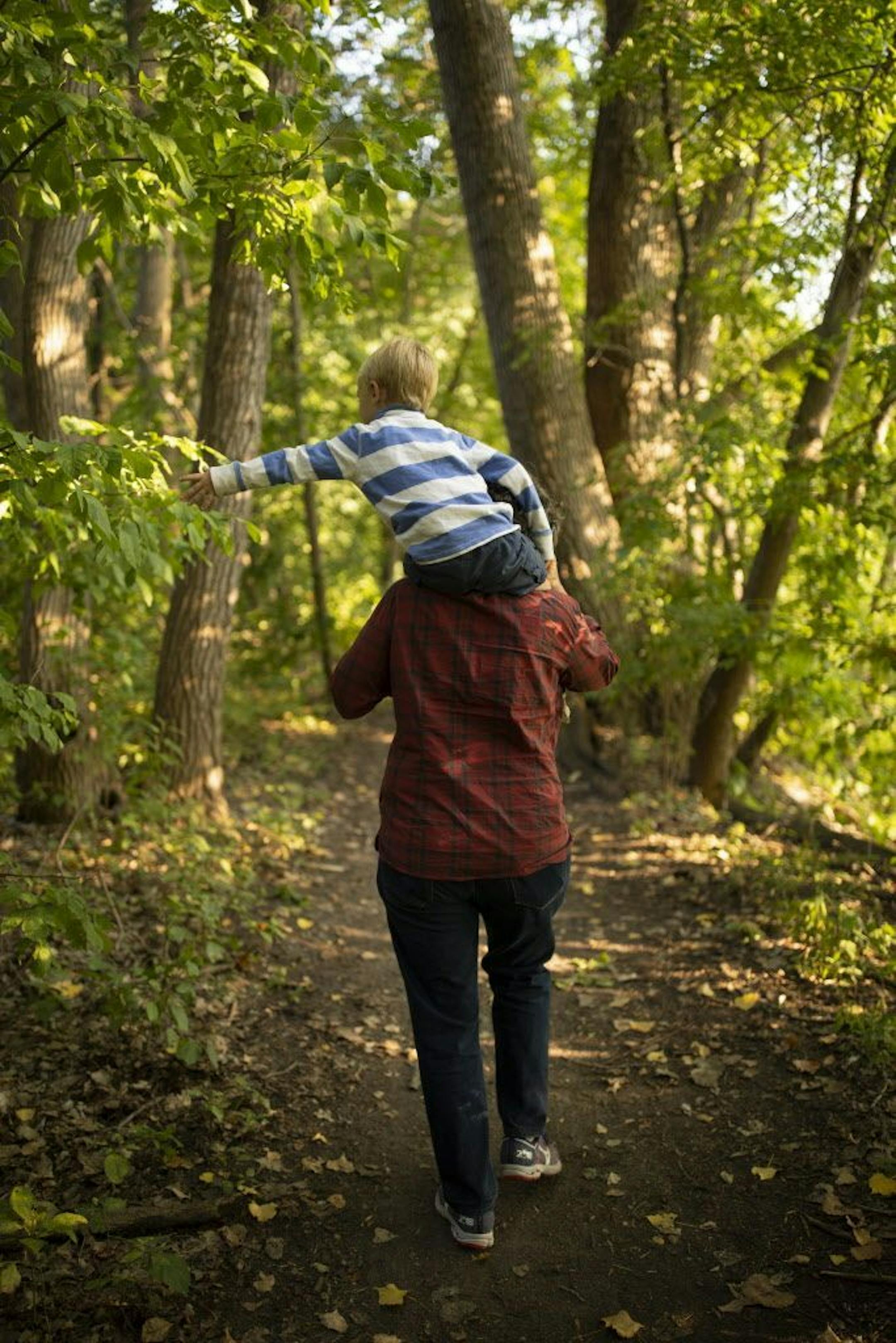 Kim Bartmann carried her son Emmitt for the trip home after a walk in the woods before dinner.