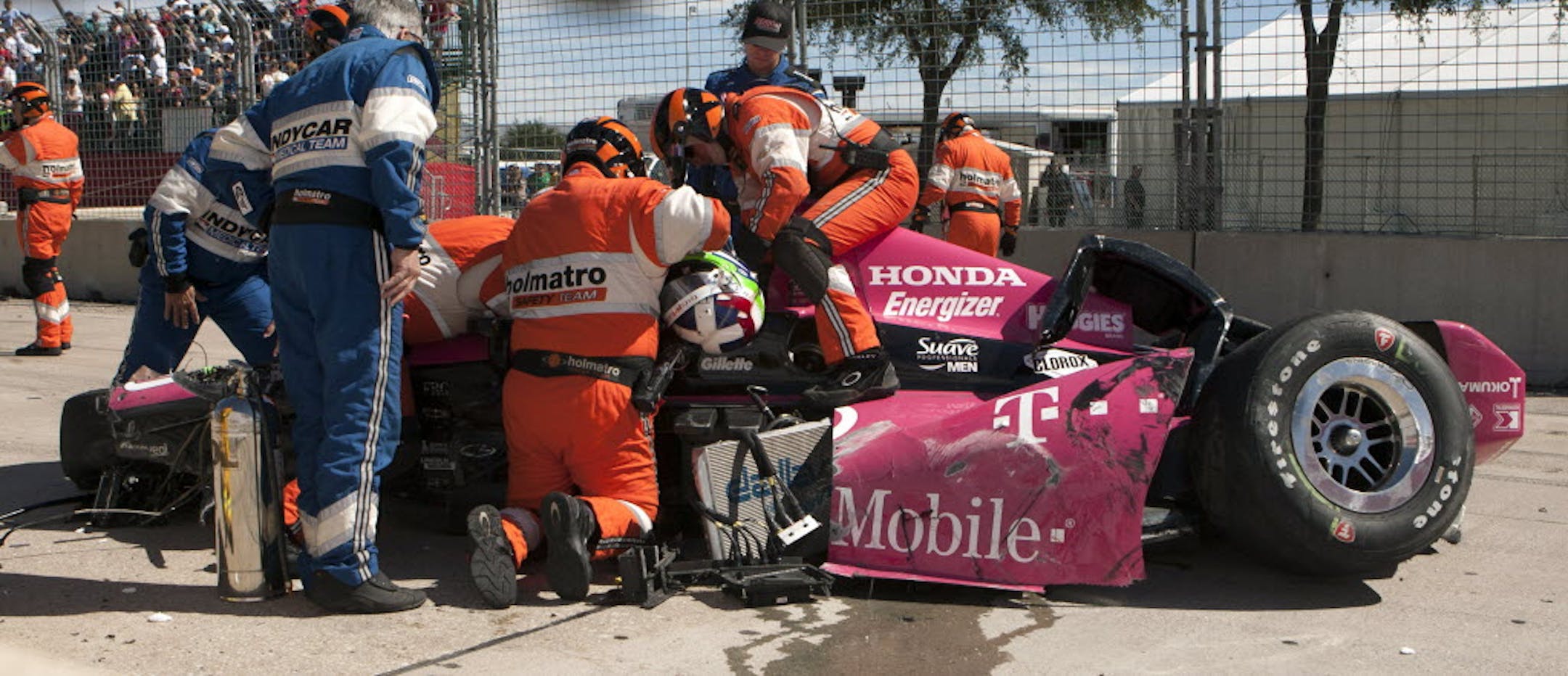 Safety team members work to remove Dario Franchitti, of Scotland, from his car after a crash during the second IndyCar Grand Prix of Houston auto race, Sunday.