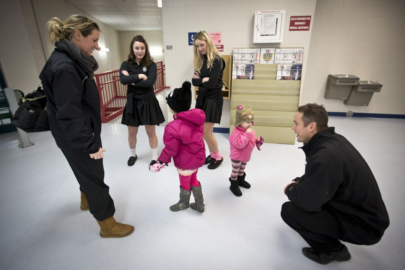 The Pohls picked up their two oldest daughters, 4-year-old Emily and 2-year-old Anna, from upstairs at the arena after practice. Team managers Annie Noel and Anna Janke watched over the Pohl sisters while the parent Pohls led practice.