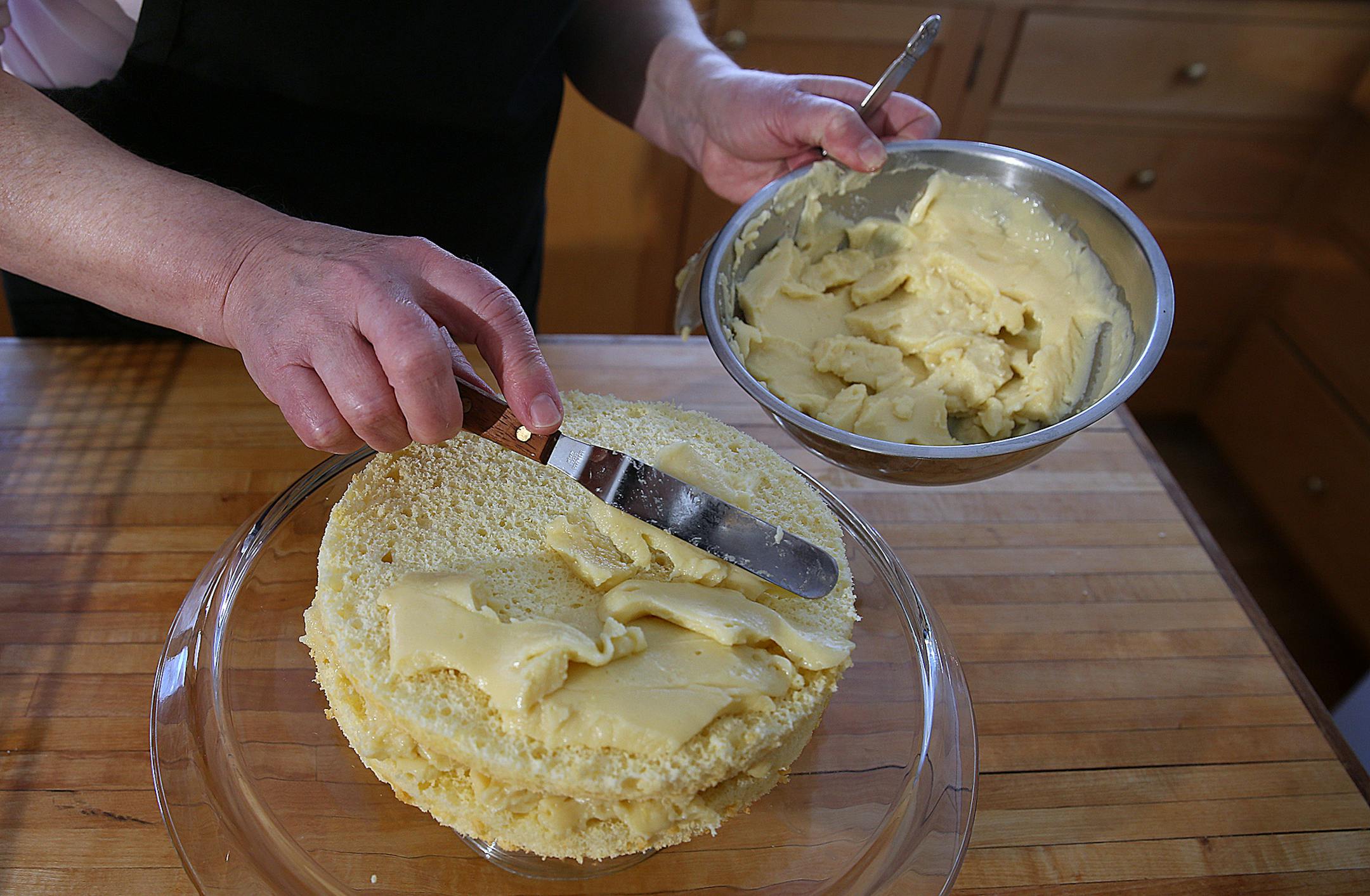 Coconut cake.] JIM GEHRZ &#x201a;&#xc4;&#xa2; jgehrz@startribune.com / Minneapolis, MN / April 4, 2014 / 1:00 PM BACKGROUND INFORMATION: Reporter Kim Ode bakes a coconut cake for Baking Central, complete with step-by-step photos showing the making of batter and custard, assembling and decorating.