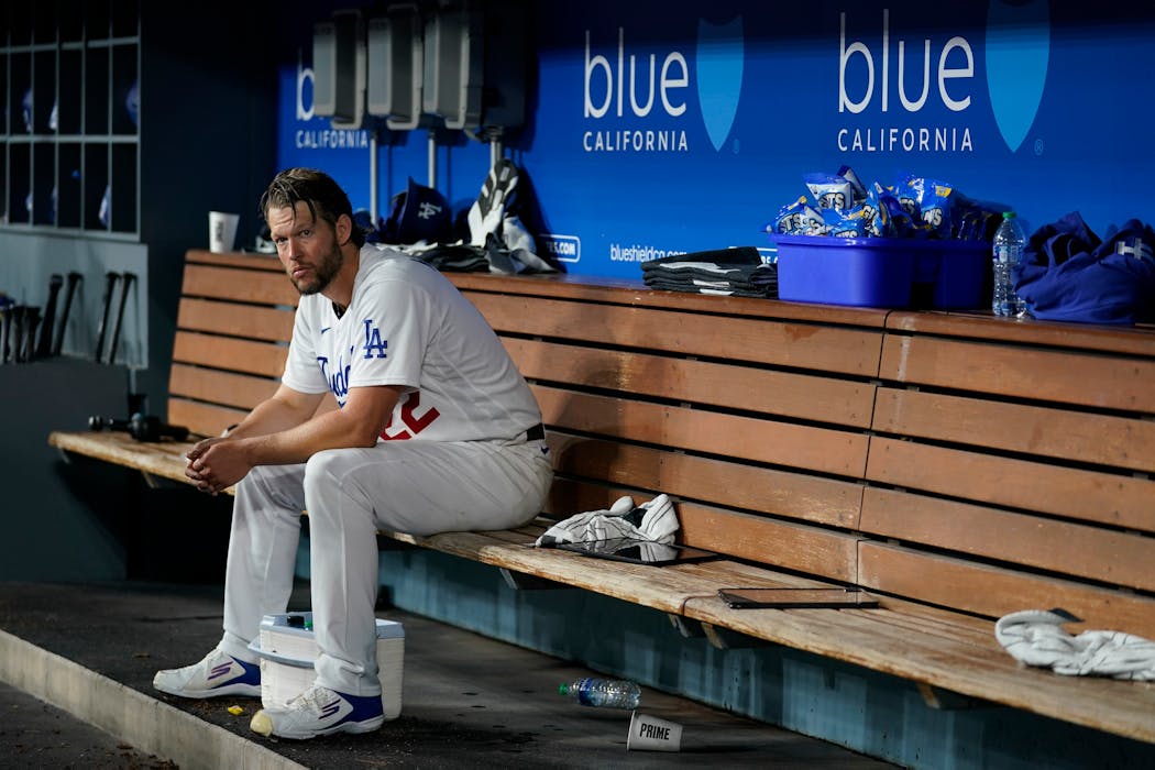 Los Angeles Dodgers starting pitcher Clayton Kershaw sits in the dugout during the fifth inning Tuesday