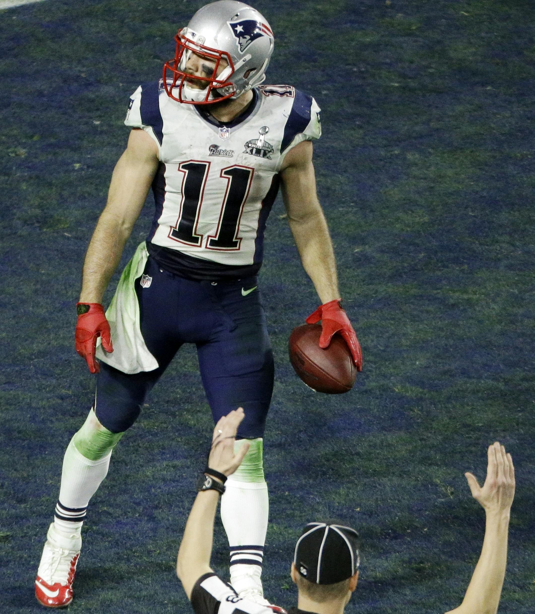 New England Patriots wide receiver Julian Edelman (11) moves in the end zone after making a touchdown catch against the Seattle Seahawks during the second half of NFL Super Bowl XLIX football game Sunday, Feb. 1, 2015, in Glendale, Ariz. (AP Photo/Charlie Riedel)