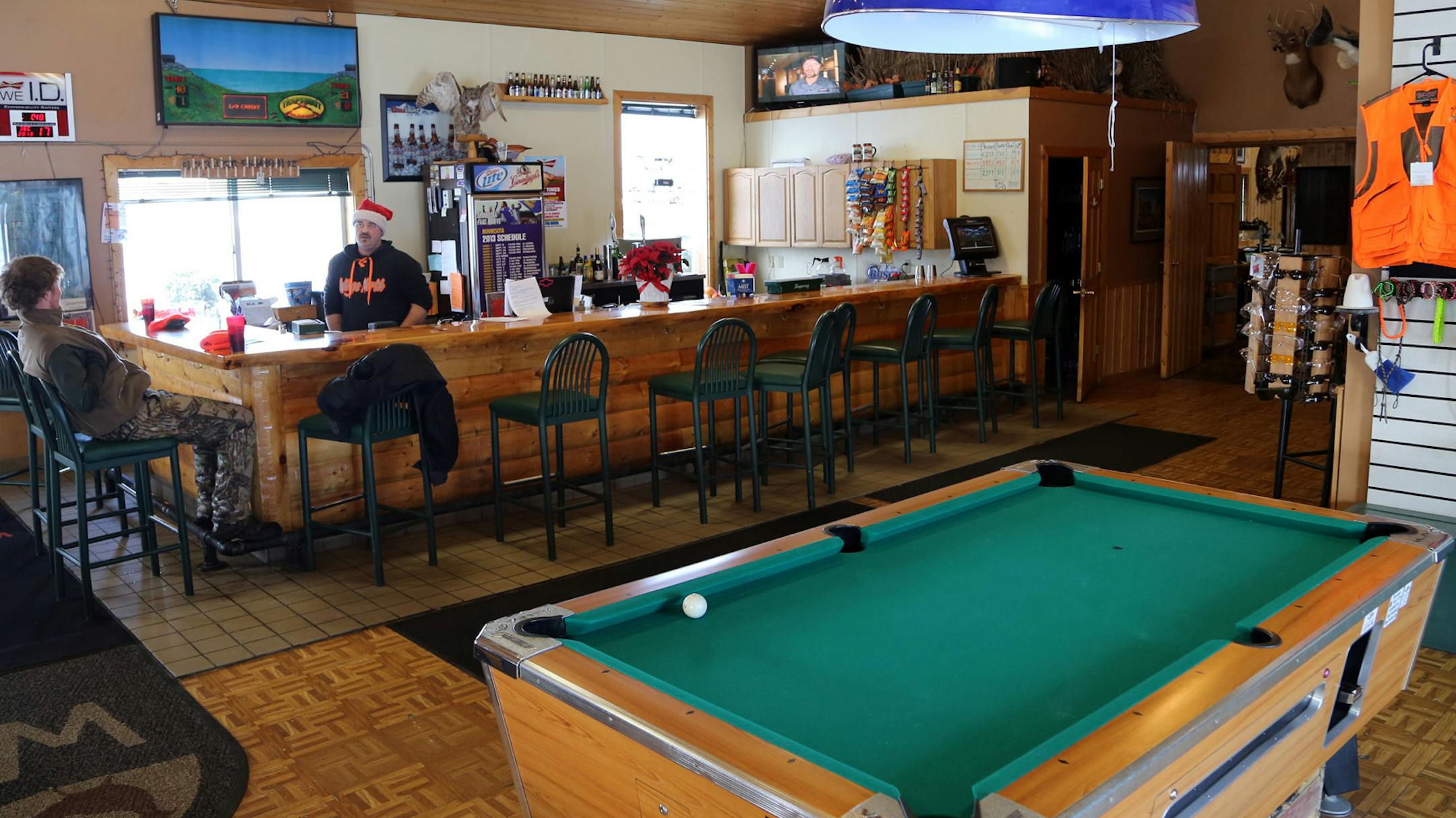 Chad Hughes, co-owner and manager of Wings North Hunt Club shown behind bar in Santa hat, said his club draws clients from Duluth as well as the Twin Cities and central Minnesota.
