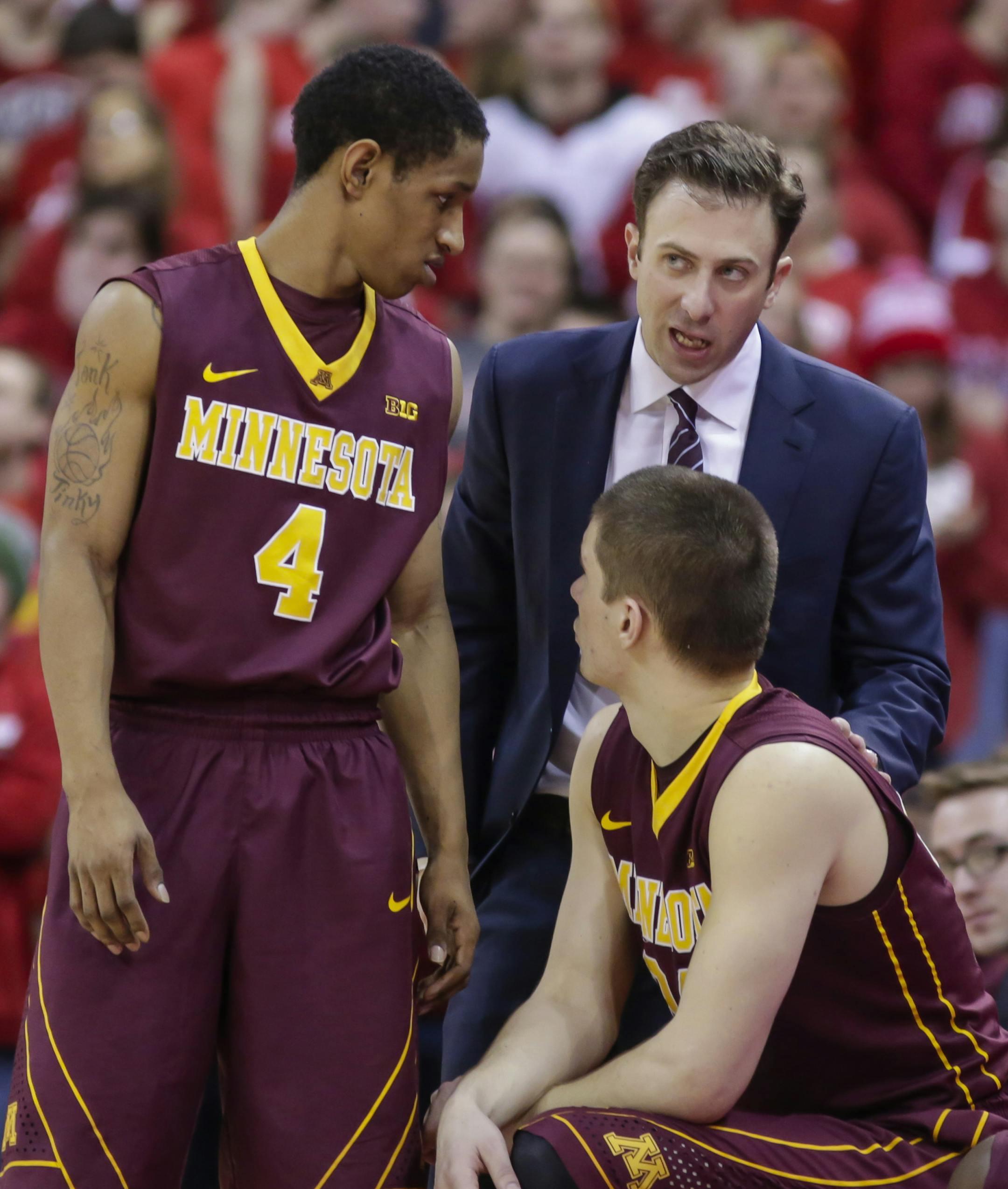 Minnesota coach Richard Pitino talks with players DeAndre Mathieu (4) and Joey King during the second half of an NCAA college basketball game Saturday, Feb. 21, 2015, in Madison, Wis. Wisconsin won 63-53. (AP Photo/Andy Manis)