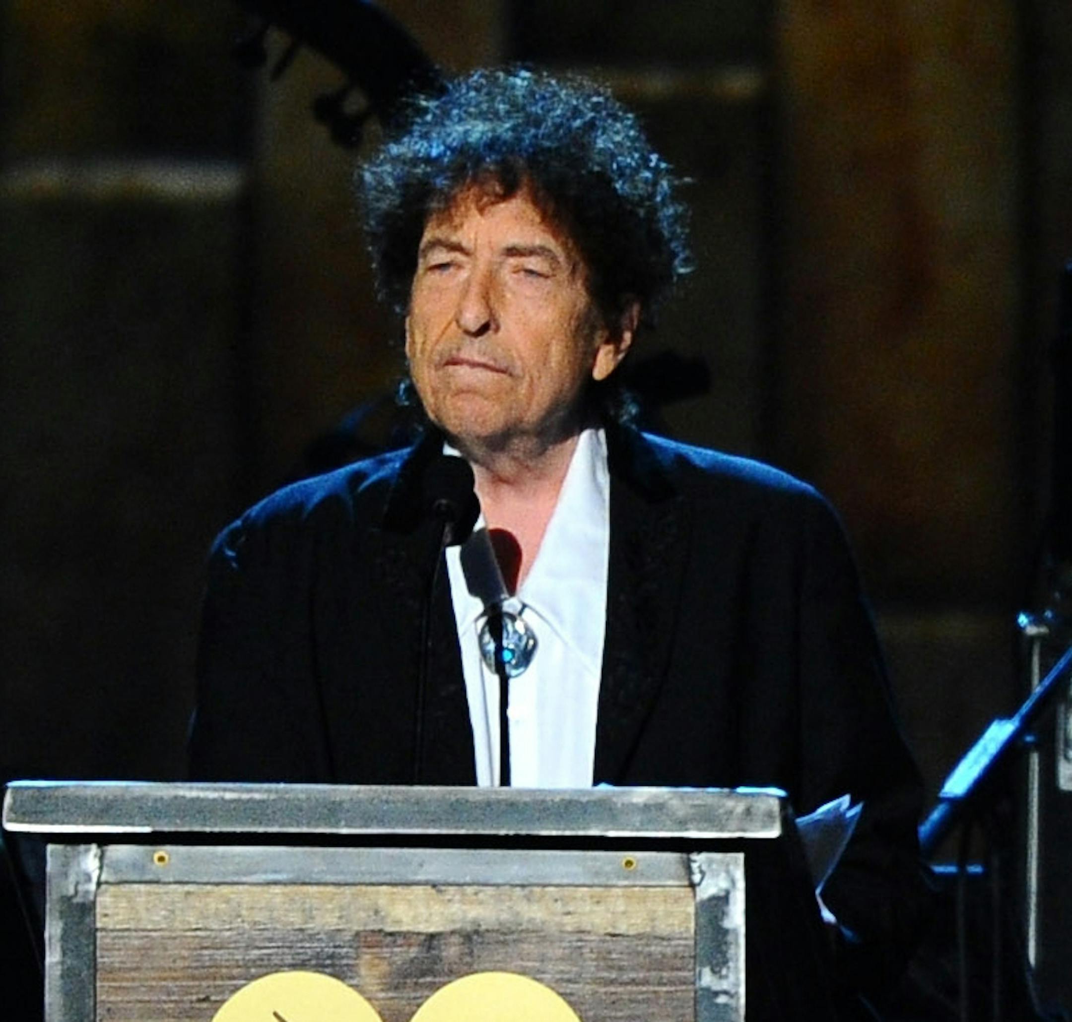 FILE - In this Feb. 6, 2015 file photo, Bob Dylan accepts the 2015 MusiCares Person of the Year award at the 2015 MusiCares Person of the Year show in Los Angeles. Dylan’s “Tarantula,” a stream-of-consciousness work first released in 1971, is finally coming out in audio. Simon & Schuster announced Tuesday, Oct. 15, 2019, that Will Patton is the narrator, reciting such lines as “raggedy ann daughter of brazos and teeth in the necklace.” Dylan first wrote “