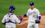 Kansas City catcher Salvador Perez and pitcher Trevor Rosenthal celebrate after Friday's game against the Twins at Kauffman Stadium