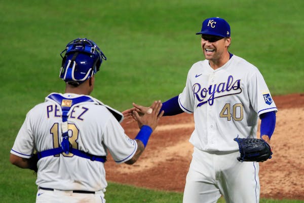 Kansas City catcher Salvador Perez and pitcher Trevor Rosenthal celebrate after Friday's game against the Twins at Kauffman Stadium