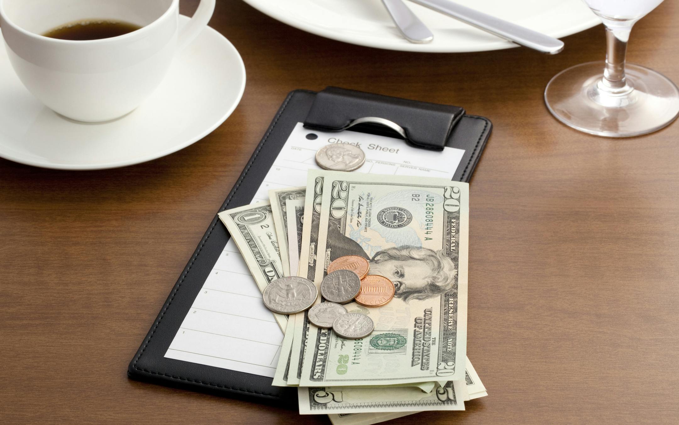 iStockphoto.com
Guest check with Cash and Coin on white background.