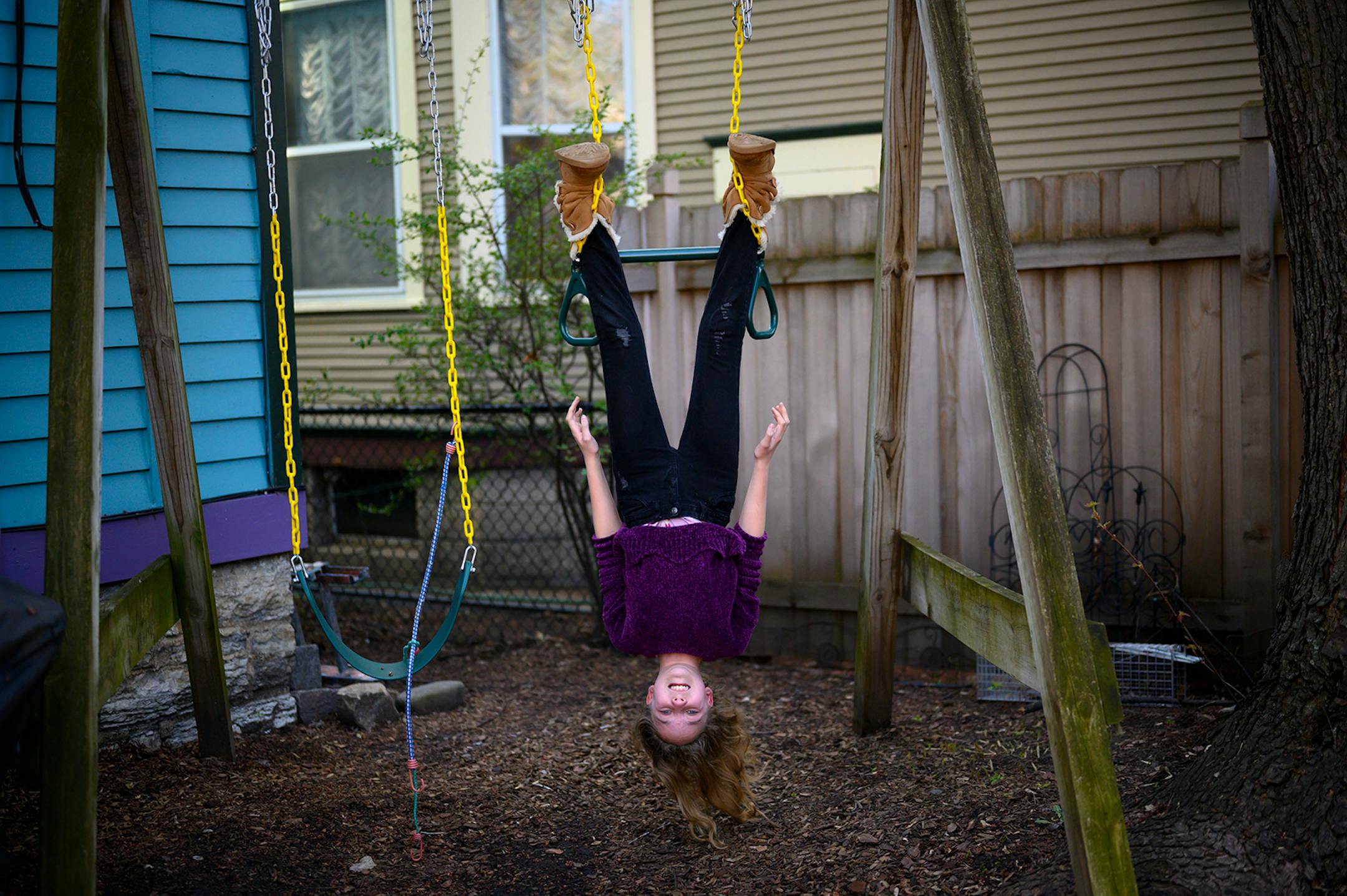 Beatrix Rhone, 12, showed off her circus skills behind her home Wednesday in St. Paul. To pass the time she's been practicing trapeze, singing and Facetiming with friends.