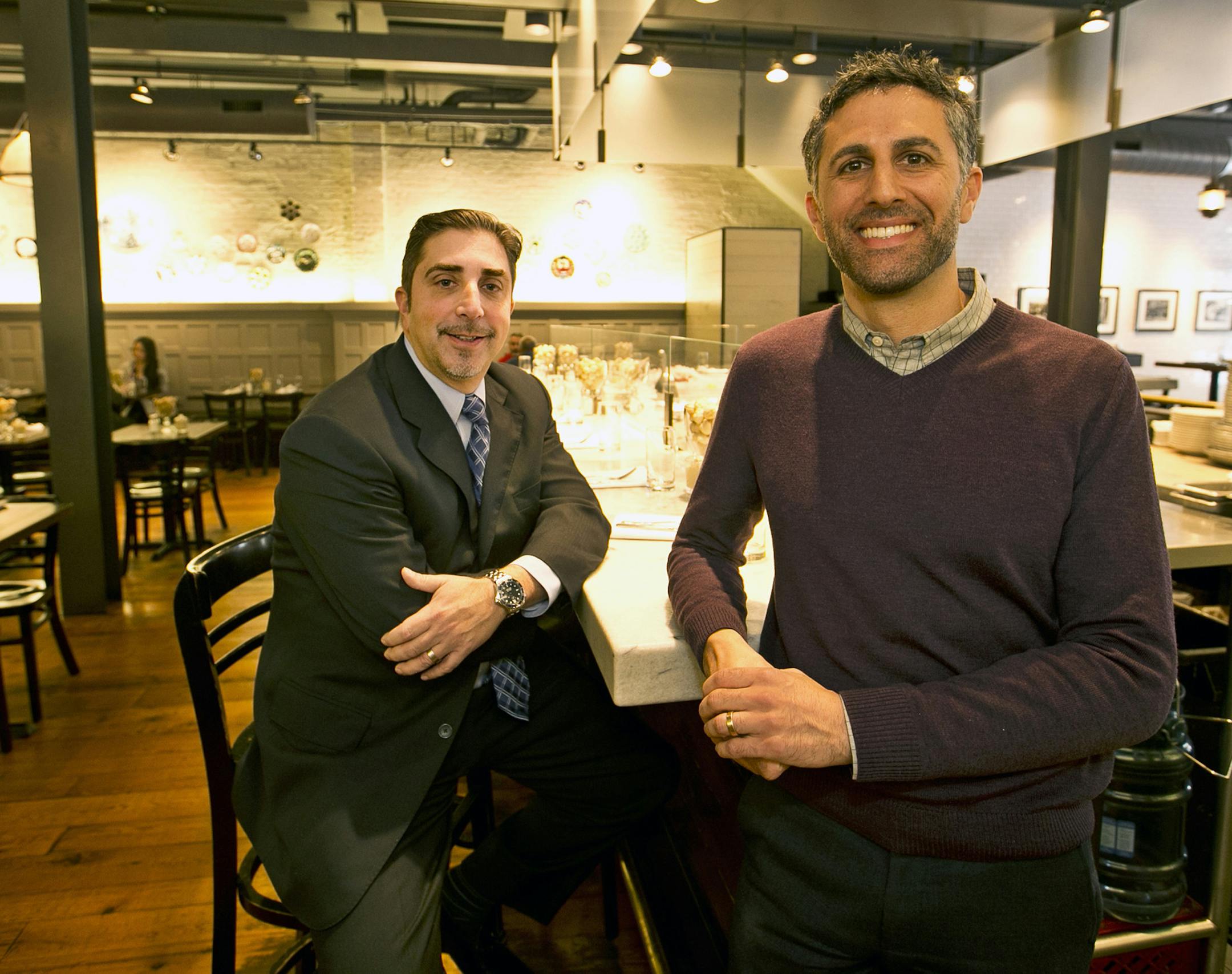 At Sanom Street Oyster House, Dan Hernandez, left, the financial guy, and owner Sam Mink, right, made sure that managers, servers and oyster shuckers at the Oyster House will be getting a unique benefit, a 401-K plan with a company match. (Michael Bryant/Philadelphia Inquirer/TNS) ORG XMIT: 1181986