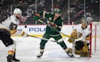 Minnesota Wild left wing Marcus Foligno (17) tried to deflect a pass from the corner while defended by Vegas Golden Knights defenseman Alex Pietrangel