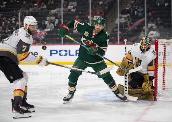 Minnesota Wild left wing Marcus Foligno (17) tried to deflect a pass from the corner while defended by Vegas Golden Knights defenseman Alex Pietrangel