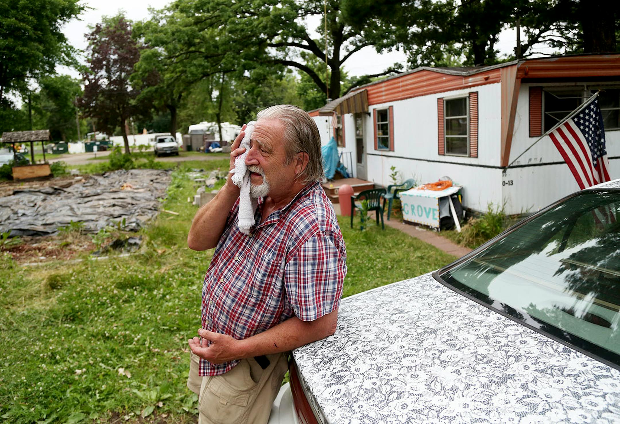 Lowry Grove mobile home park resident Bill McConnell, a retiree who has lived at Lowry Grove for 31 years, wipes away sweat outside his home Thursday, June 29, 2017, in St. Anthony, MN. "This is where I was going to retire," McConnell said. Lowry Grove closed it's gate and all residents had to be gone by 12 midnight on July 1, the space slated to be redeveloped into multiple-family housing.