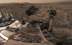 This composite image from Aug. 9, 2018 photos made available by NASA shows the Curiosity rover at Vera Rubin Ridge on Mars. A thin layer of dust is vi