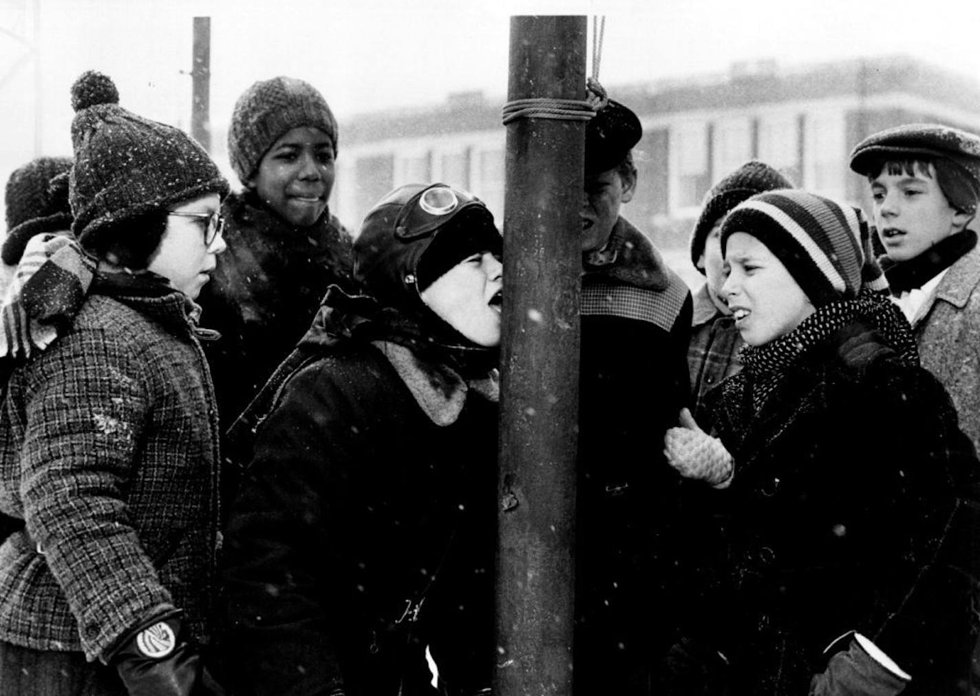 November 30, 1984 Ralphie (Peter Billingsley), left, Schwartz (R.D.Robb), right, and friends cringe after Flick (Scott Schwartz) takes a dare to put his tongue on a freezing pole in MGM's "A Christmas Story," a nostalgic comedy from MGM/UA Entertainment Co. Critic's choice/Movies Is this the beginning of an annual tradition? Let's hope so, because "A Christmas Story" is a delightful reminiscence of growing up in northern Indiana, when finding a Red Ryder rifle under the tree on Christmas morning