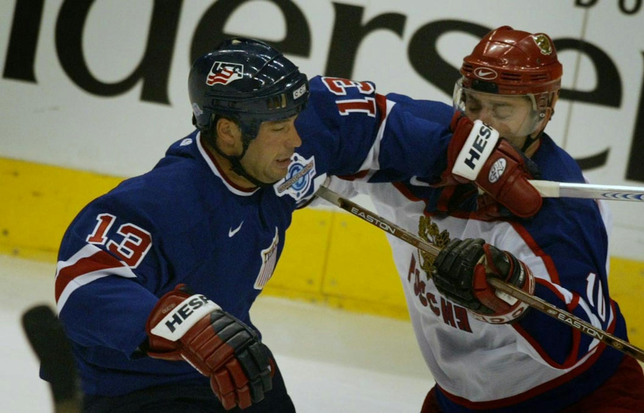 Jim Gehrz/Minneapolis Star Tribune St. Paul/September 2, 2004/7:00 PM Team USA's Bill Guerin (left) battles Team Russia's Oleg Tverdovsky for a loose puck in the second perios in World Cup of hockey 2004 action at the Xcel Energy Center Thursday, September 2, 2004.