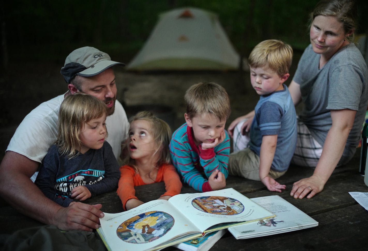 Lydia Haschig,3, asks a question during story time as brother Gus,5, looks on next to her. Her uncle Joe Malkovich, aunt Sarah, and cousins Hannah and Daniel, 5 and 3, brought them to camp for one night.] At William O'Brien State Park exemplifies camping's popularity across the state ballooning as more Minnesotans seek inexpensive, close-to-home vacations and experience the mental and physical health benefits of spending time in nature. Richard Tsong-Taatarii/Richard Tsong-taatarii@startribune.c